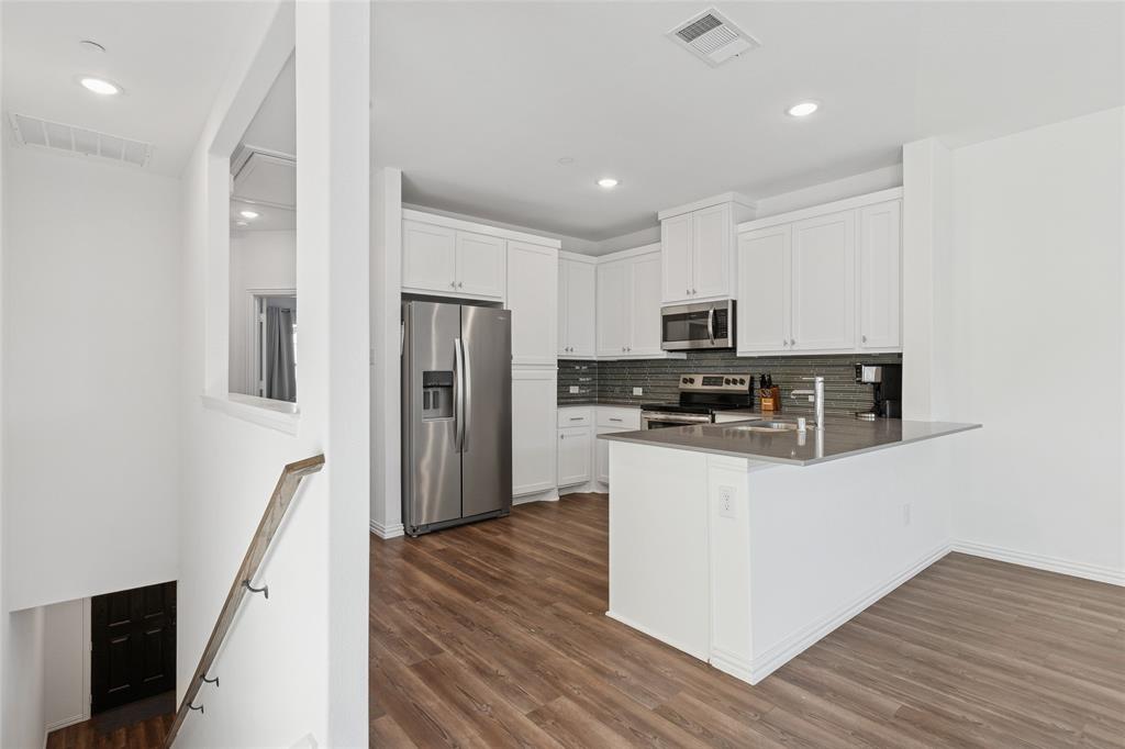 4703 Kindred Street Haltom City, TX 76117 - Photo 9 of 23 a kitchen with stainless steel appliances granite countertop a refrigerator and a stove top oven