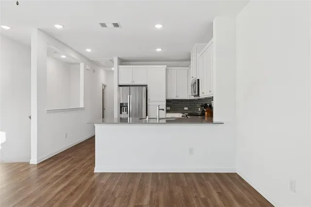 a view of kitchen with wooden floor
