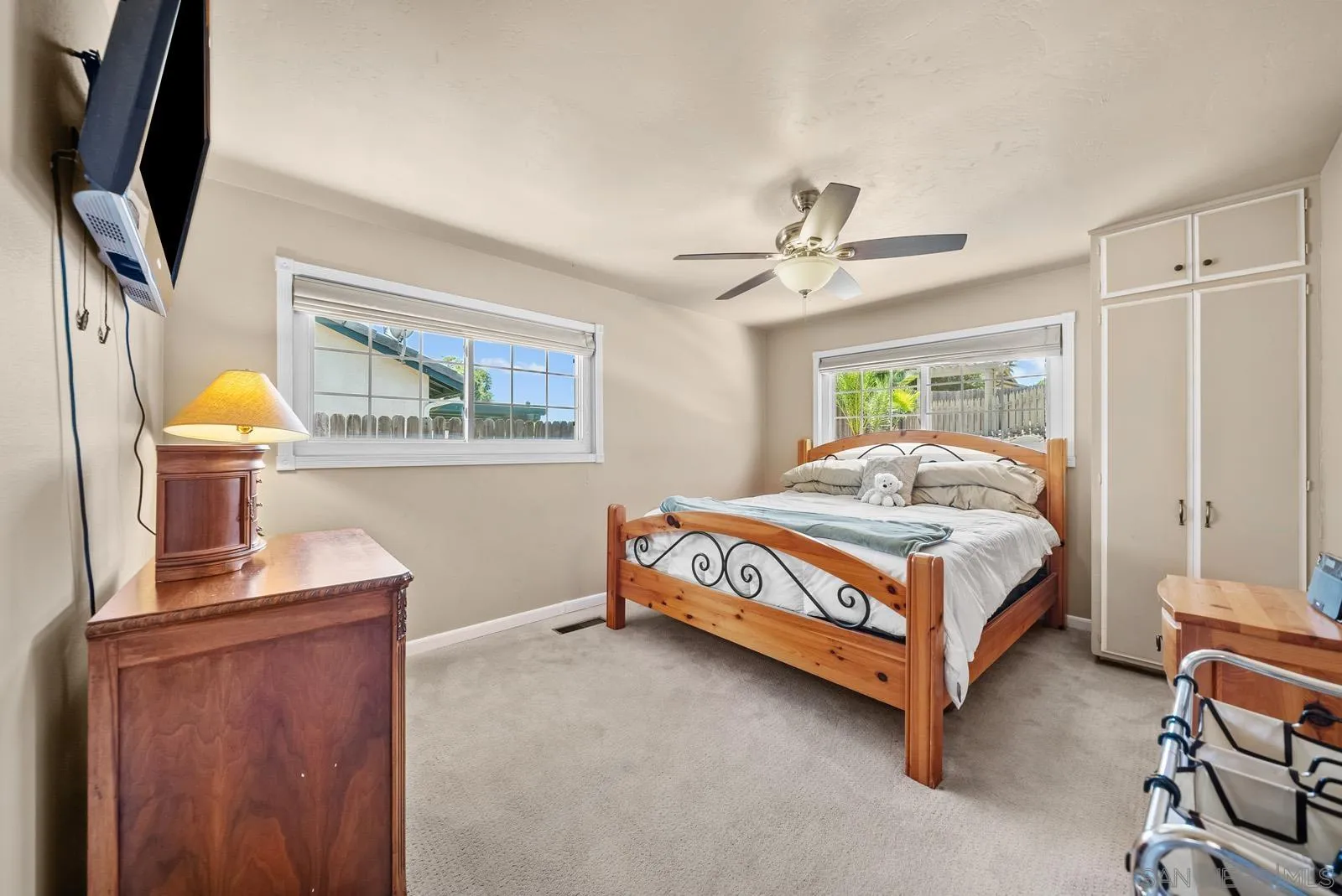 2327 Morro Road Fallbrook, CA 92028 - Photo 26 of 75 a bedroom with a bed a chandelier and a flat tv screen on dresser