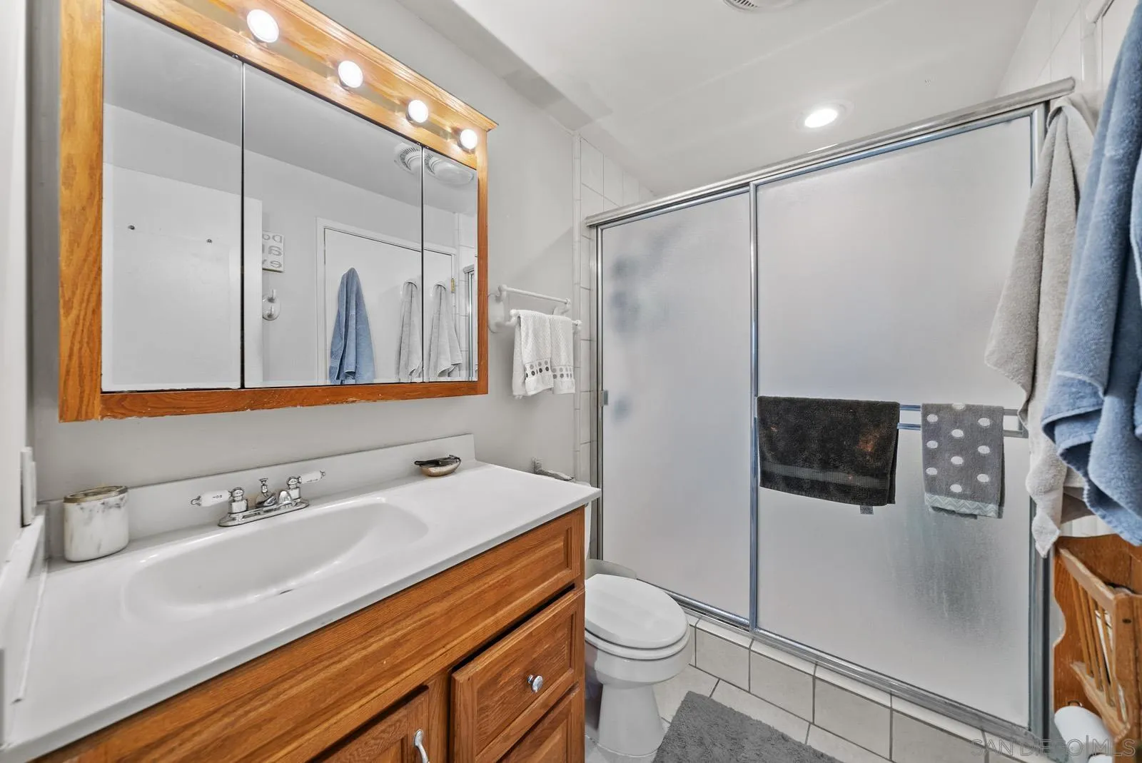 2327 Morro Road Fallbrook, CA 92028 - Photo 30 of 75 a bathroom with a sink a toilet a mirror and shower