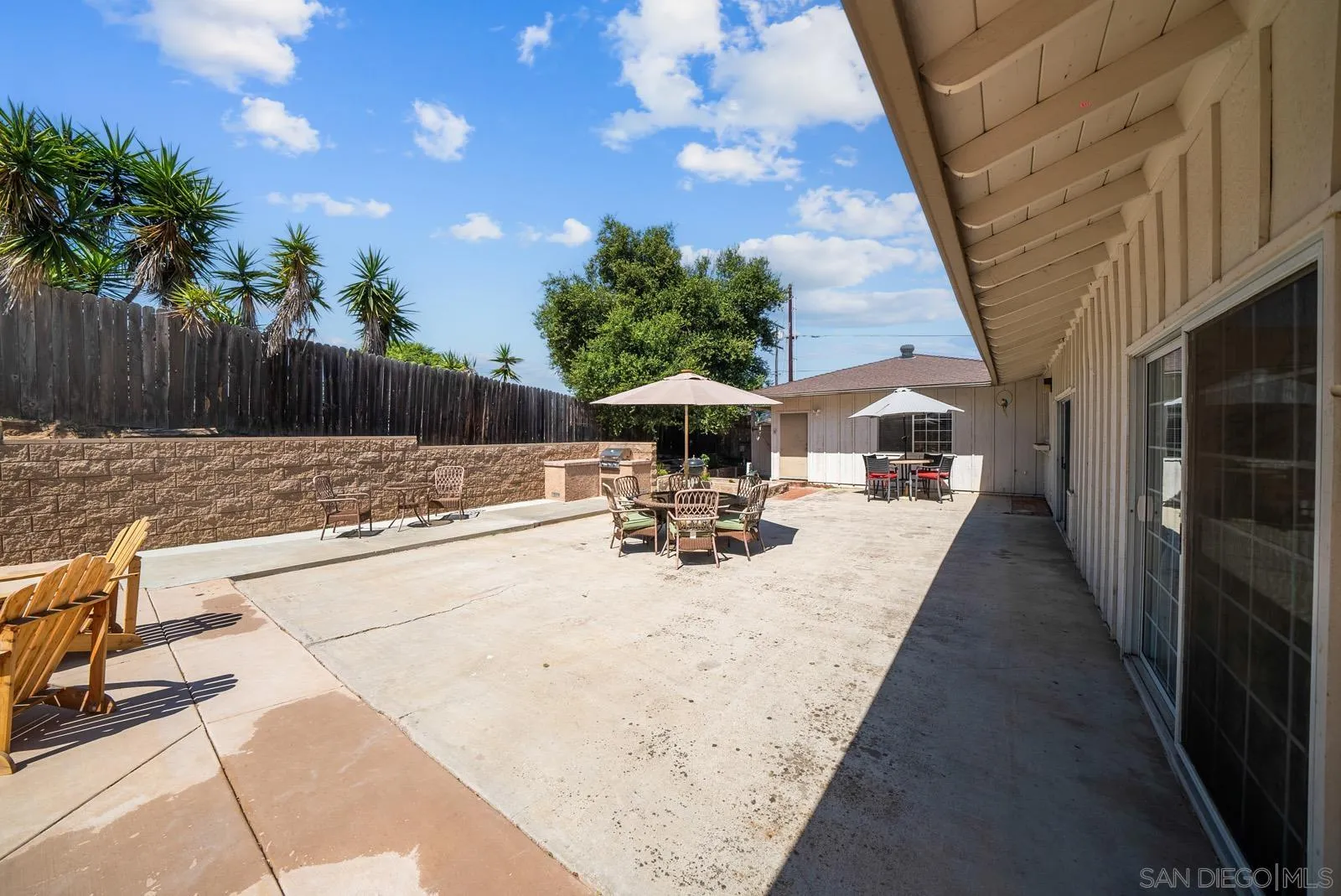 2327 Morro Road Fallbrook, CA 92028 - Photo 45 of 75 a view of a patio with table and chairs with wooden fence and plants