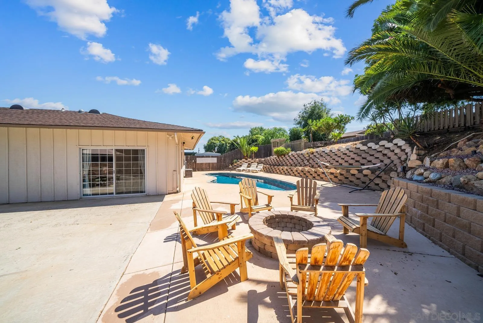 2327 Morro Road Fallbrook, CA 92028 - Photo 50 of 75 a view of a patio with table and chairs with wooden floor and fence