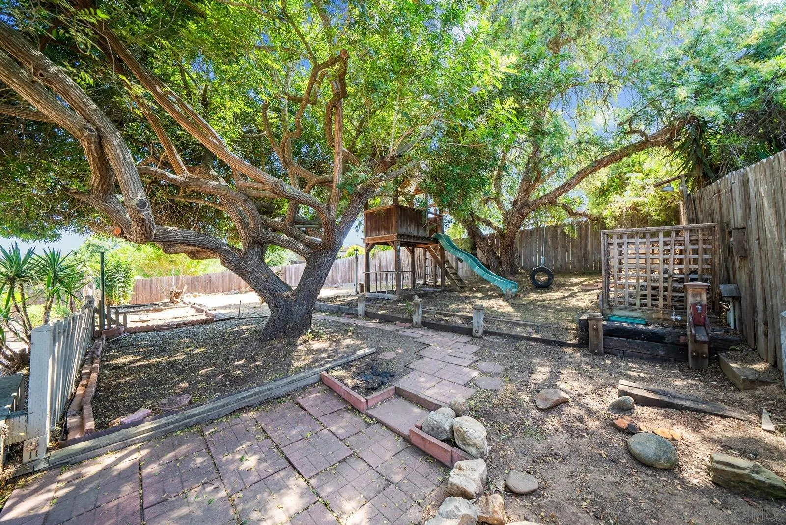 2327 Morro Road Fallbrook, CA 92028 - Photo 52 of 75 a backyard of a house with barbeque oven and outdoor seating
