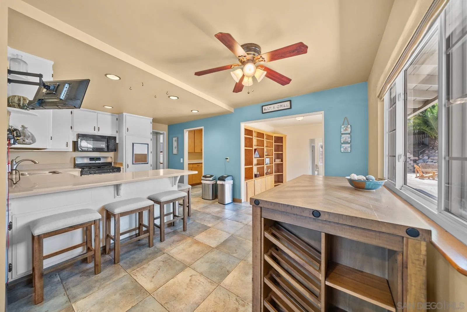 2327 Morro Road Fallbrook, CA 92028 - Photo 6 of 75 a room with stainless steel appliances kitchen island granite countertop a table chairs sink and cabinets