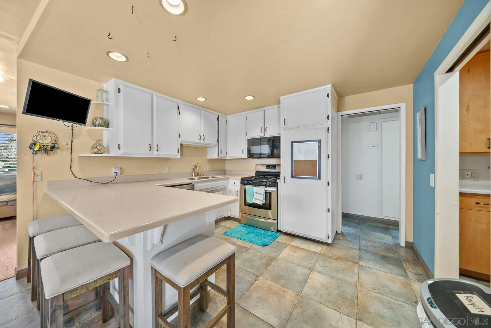 2327 Morro Road Fallbrook, CA 92028 - Photo 9 of 75 a kitchen with a refrigerator a stove top oven a sink a counter top space and cabinets