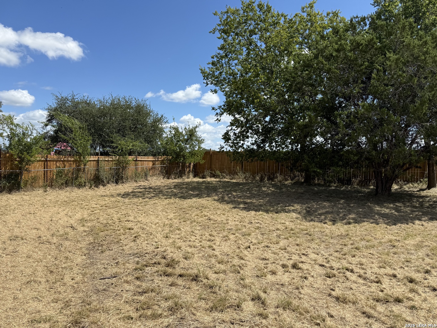 153 Colt Court Bandera, TX 78003 - Photo 3 of 5 a backyard of a house with lots of green space