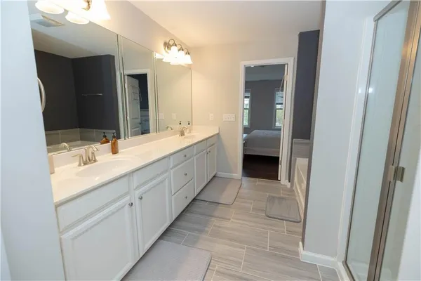 a bathroom with a double vanity sink and a mirror