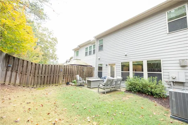 a backyard of a house with table and chairs