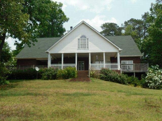 231 Harris Road Jackson, GA 30233 - Photo 1 of 1 a view of a house next to a yard with plants and trees