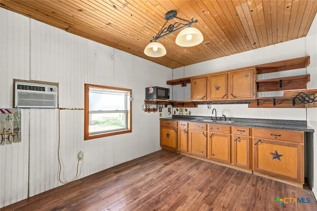 a kitchen with stainless steel appliances granite countertop a stove and cabinets