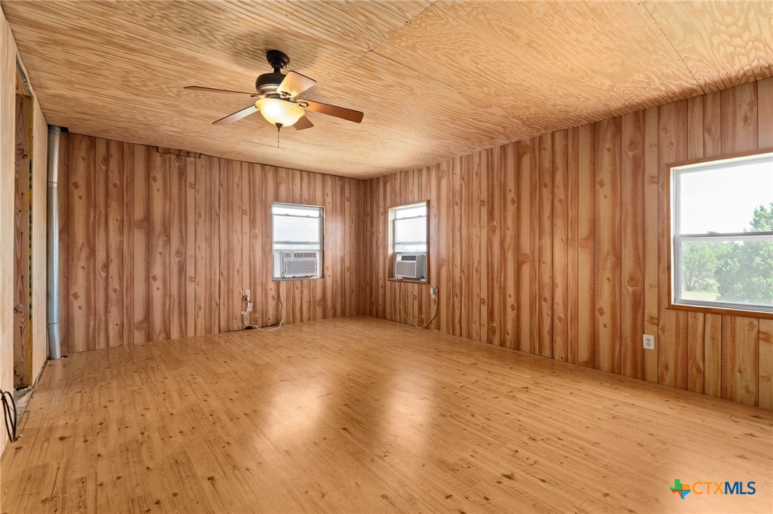 586 Private Road 3448 Kempner, TX 76539 - Photo 17 of 40 an empty room with wooden floor fan and windows