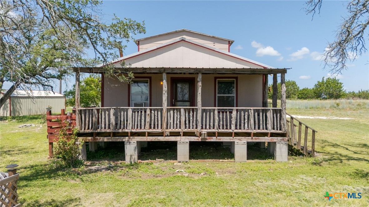 586 Private Road 3448 Kempner, TX 76539 - Photo 4 of 40 a balcony with table and chairs a barbeque with wooden floor and fence
