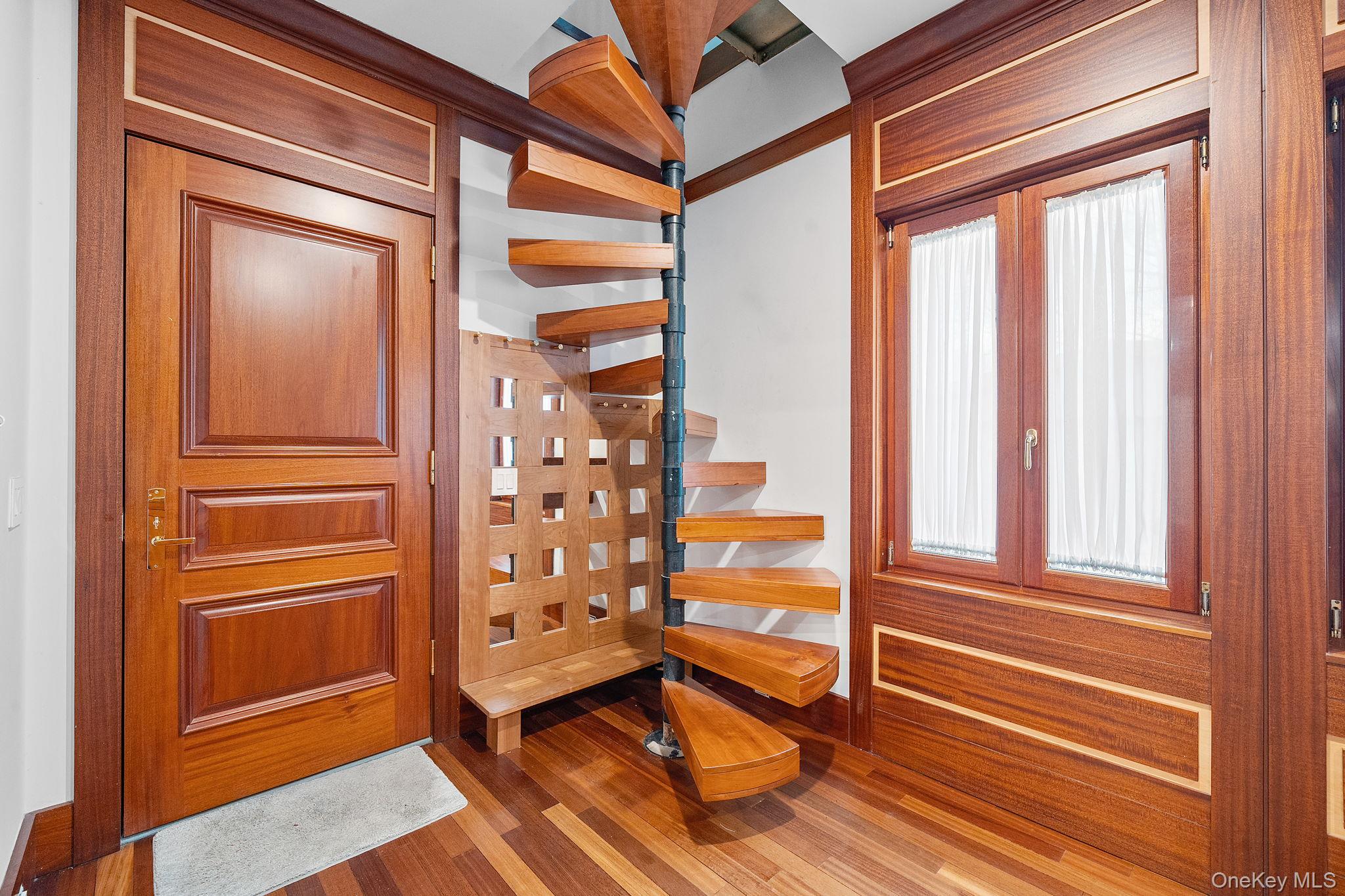 181 Walnut Street Lynbrook, NY 11563 - Photo 11 of 46 Foyer entrance with dark wood finished floors and stairs