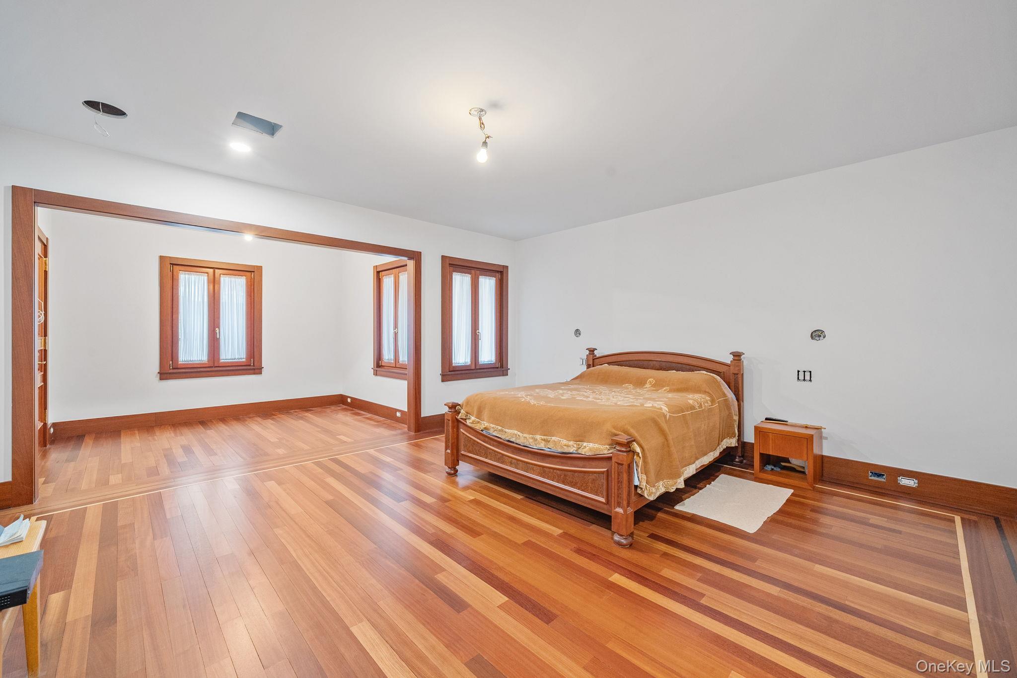 181 Walnut Street Lynbrook, NY 11563 - Photo 19 of 46 Bedroom featuring light wood-style floors and baseboards