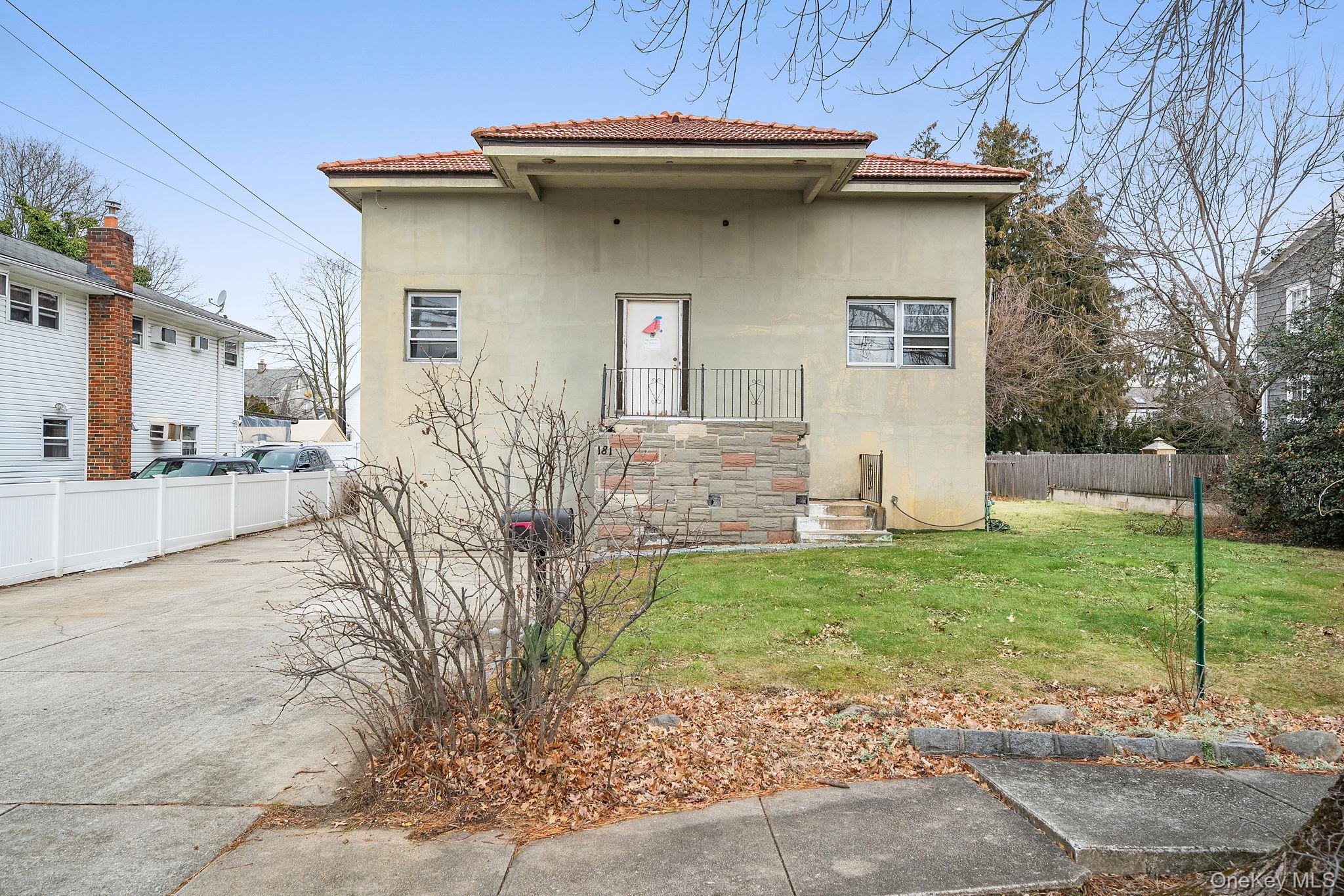 181 Walnut Street Lynbrook, NY 11563 - Photo 2 of 46 View of front of property featuring a tile roof and stucco siding