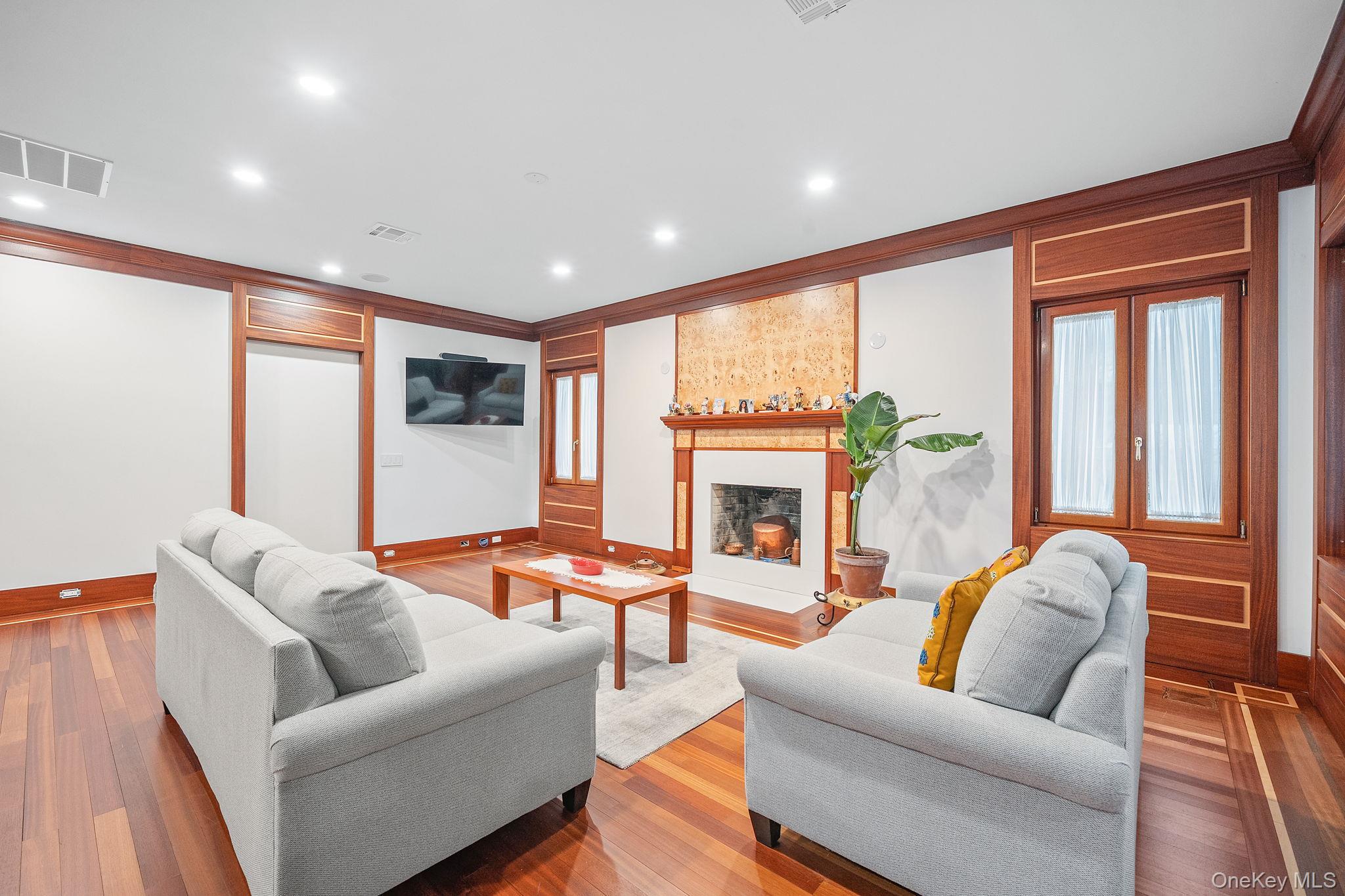 181 Walnut Street Lynbrook, NY 11563 - Photo 6 of 46 Living area with a fireplace, recessed lighting, wood finished floors, and ornamental molding