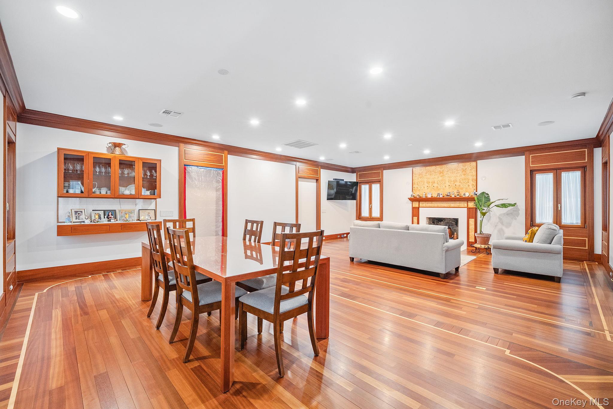181 Walnut Street Lynbrook, NY 11563 - Photo 7 of 46 Dining room with a fireplace, light wood-style flooring, crown molding, and recessed lighting