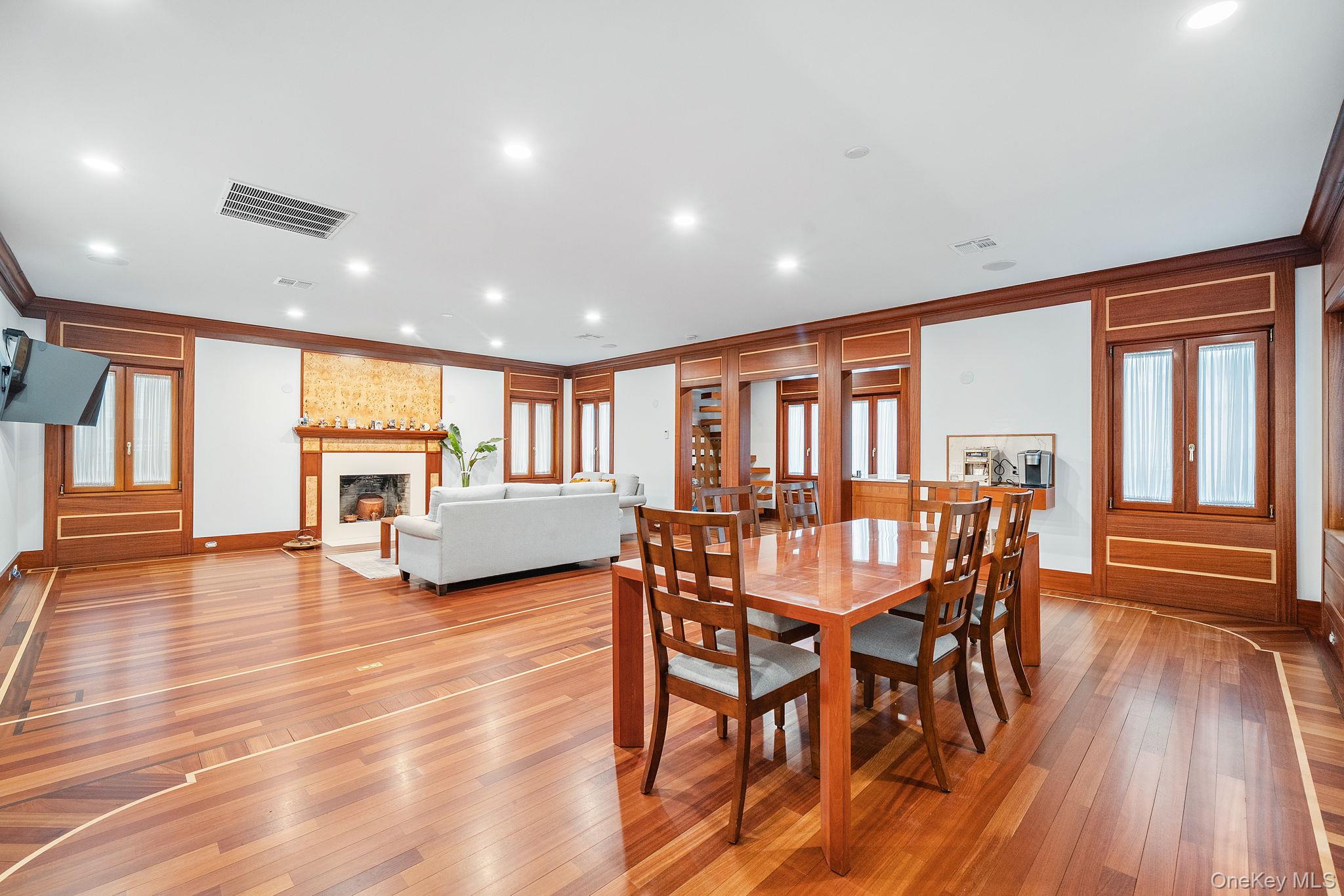 181 Walnut Street Lynbrook, NY 11563 - Photo 8 of 46 Dining space with recessed lighting, a large fireplace, ornamental molding, and light wood-type flooring