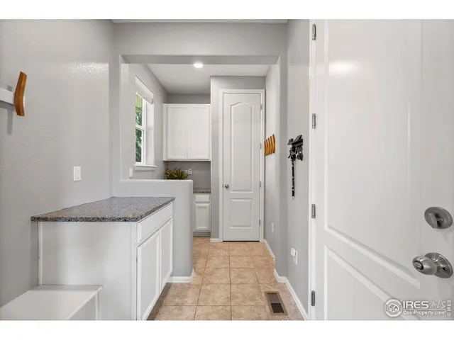 a bathroom with a granite countertop sink a mirror and shower