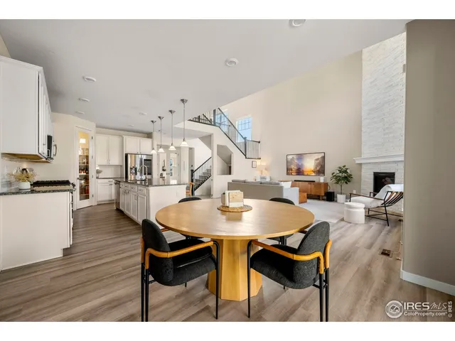 a dining room with furniture and wooden floor