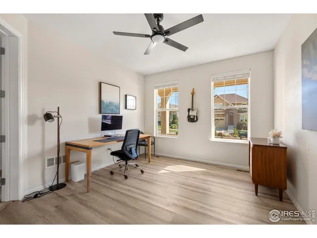 a workspace with furniture hardwood and a window