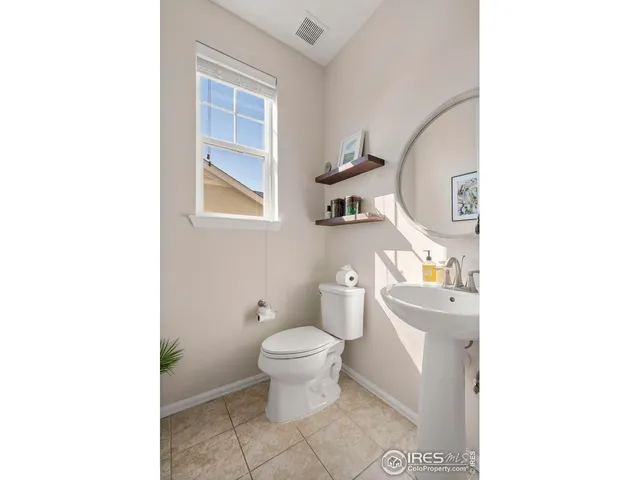 a bathroom with a toilet and a mirror
