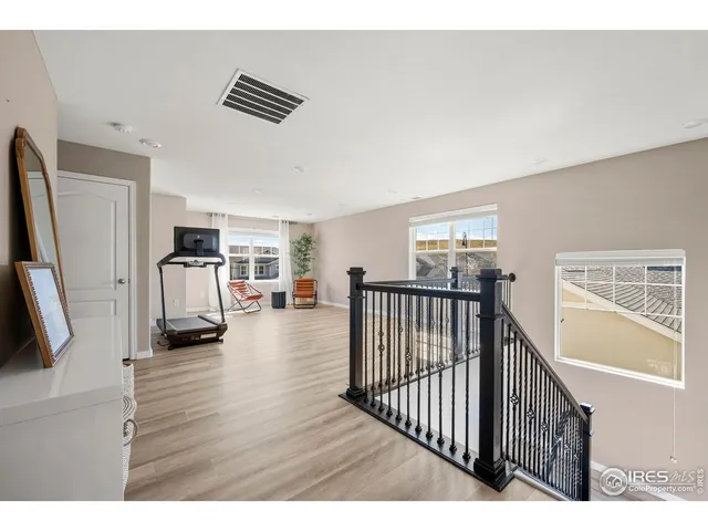 a view of a livingroom with furniture hardwood floor and a flat screen tv