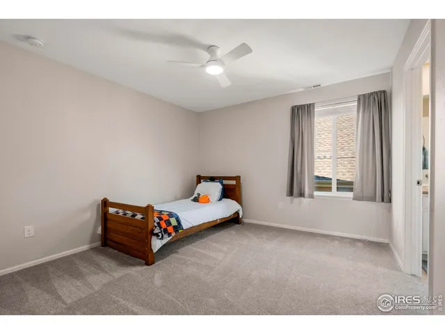 a living room with furniture and a ceiling fan