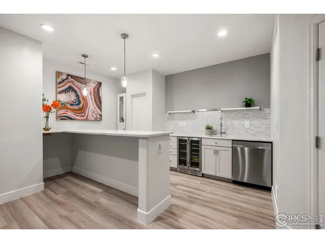 a open kitchen with kitchen island granite countertop a stove top oven a sink a counter space and cabinets