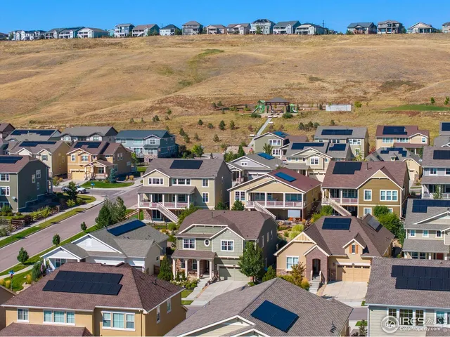 an aerial view of house with ocean view