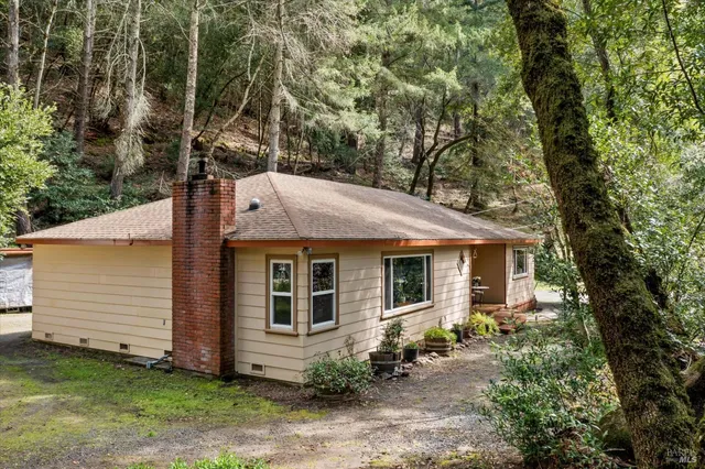a deck area with table and chairs and potted plants