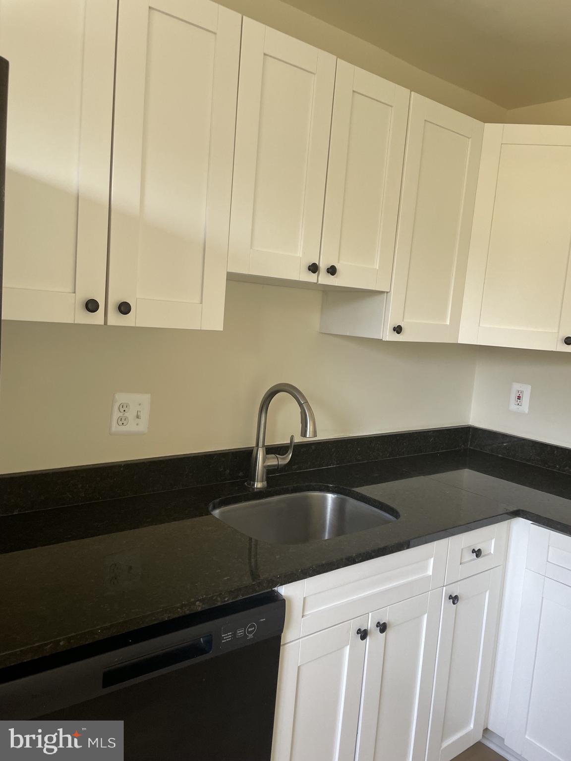 1287 Springtide Place Herndon, VA 20170 - Photo 8 of 23 a kitchen with a sink and cabinets