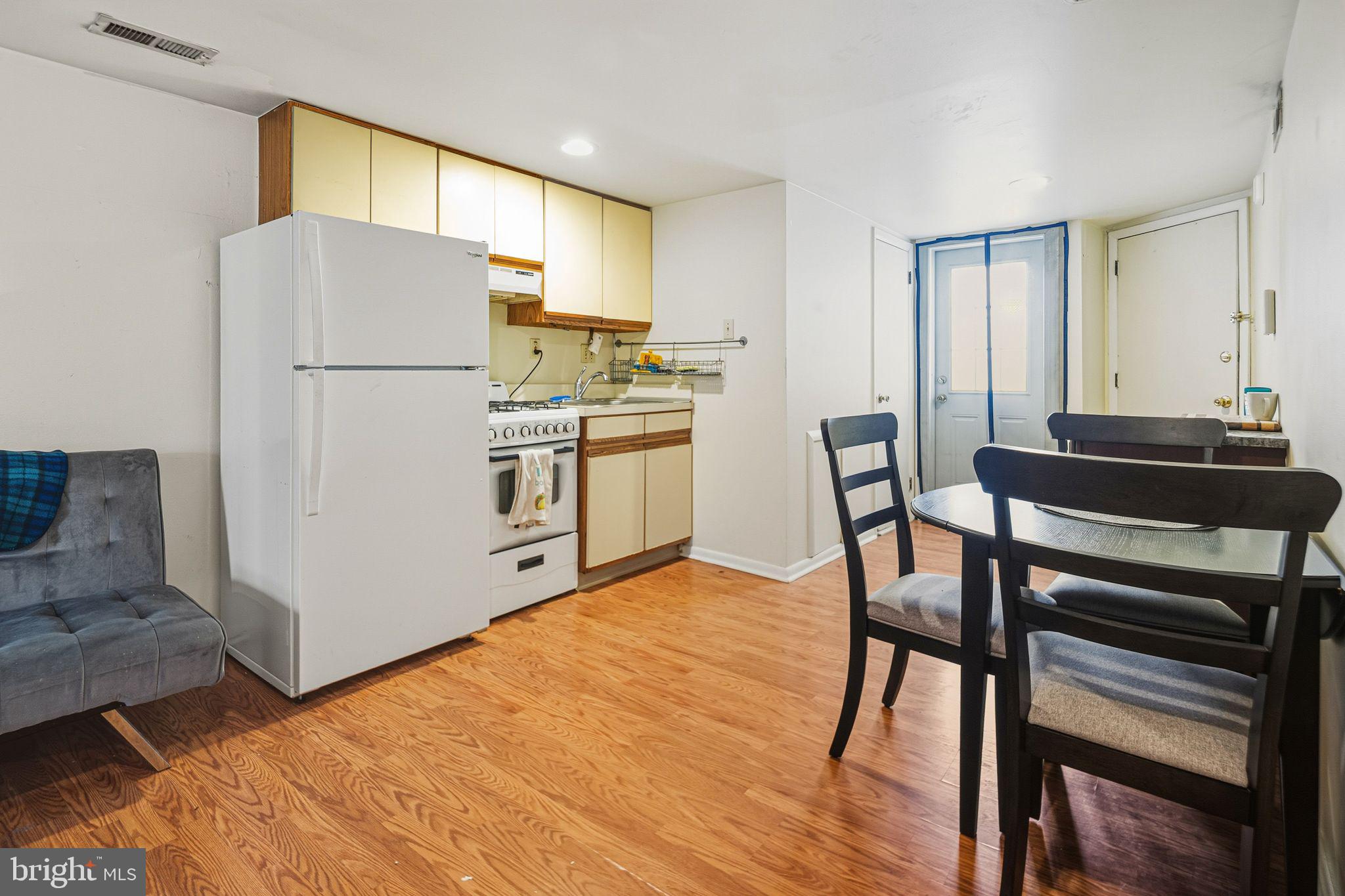 788 South 2nd Street, Unit 3 Philadelphia, PA 19147 - Photo 5 of 13 a kitchen with stainless steel appliances a refrigerator a stove a dining table and chairs