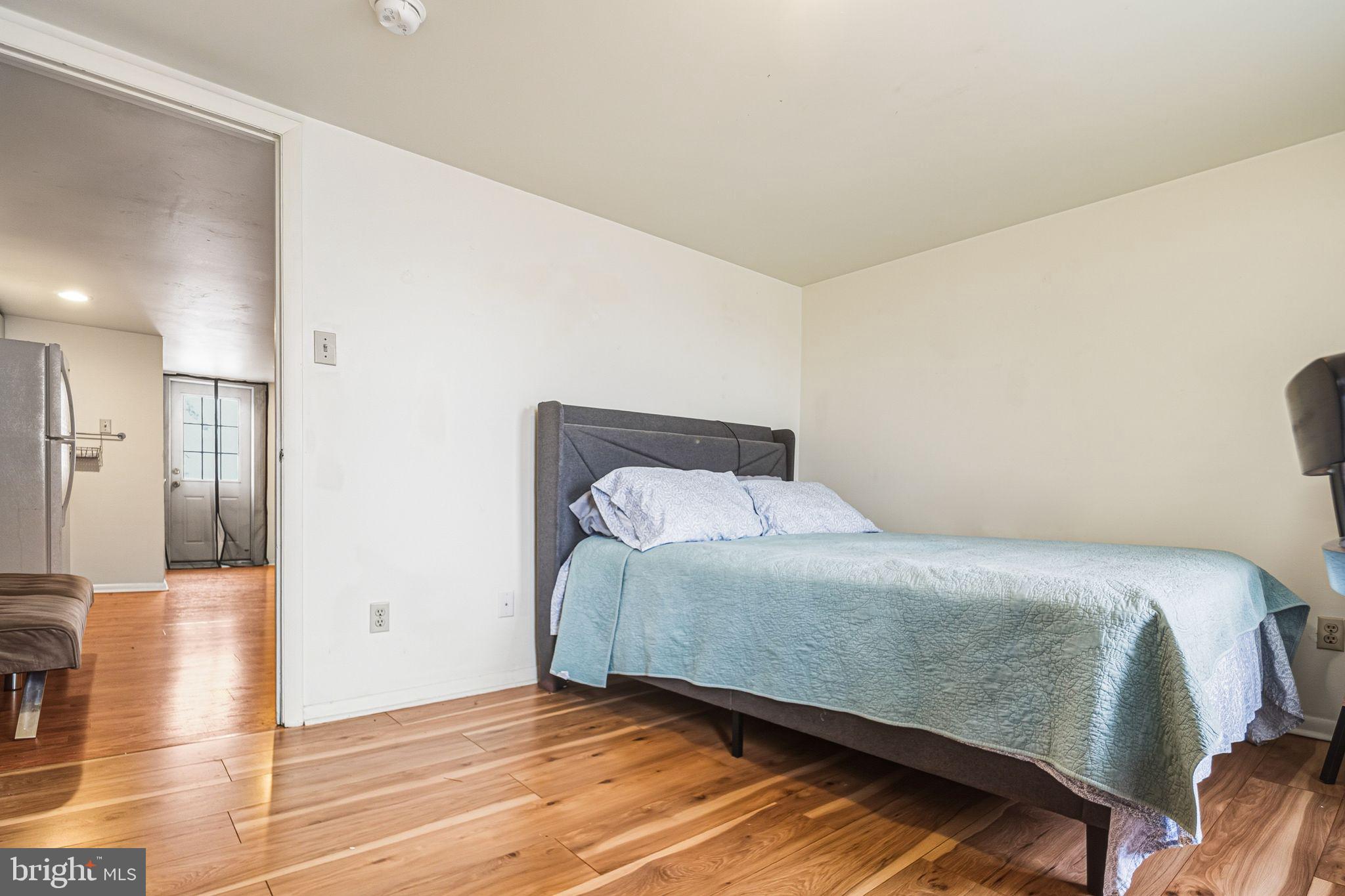 788 South 2nd Street, Unit 3 Philadelphia, PA 19147 - Photo 10 of 13 a bedroom with a bed and wooden floor