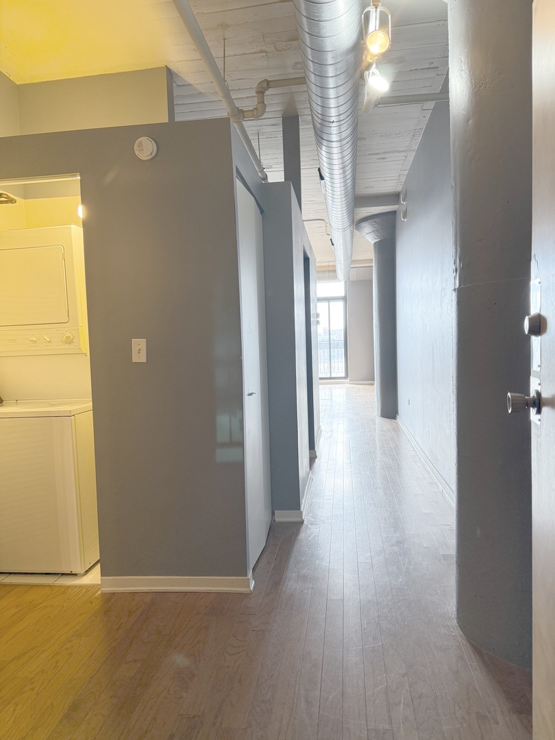 1525 South Sangamon Street, Unit 414 Chicago, IL 60608 - Photo 3 of 22 a view of a hallway with wooden floor