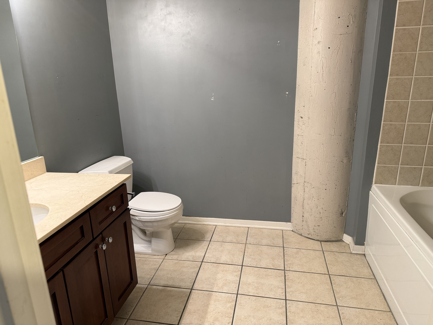 1525 South Sangamon Street, Unit 414 Chicago, IL 60608 - Photo 6 of 22 a bathroom with a granite countertop sink and a toilet