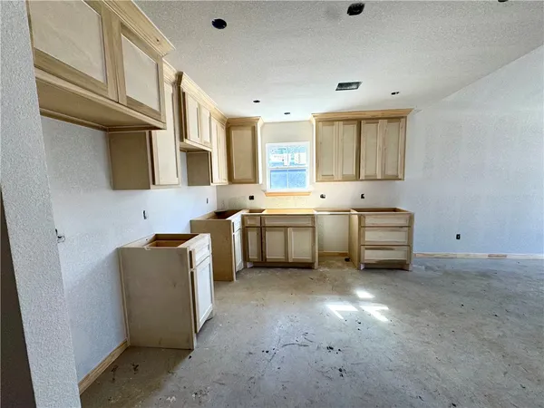 a utility room with cabinets washer and dryer