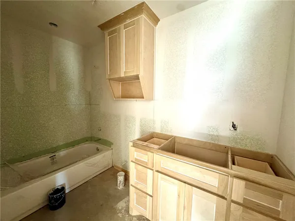 a bathroom with a bathtub and a sink