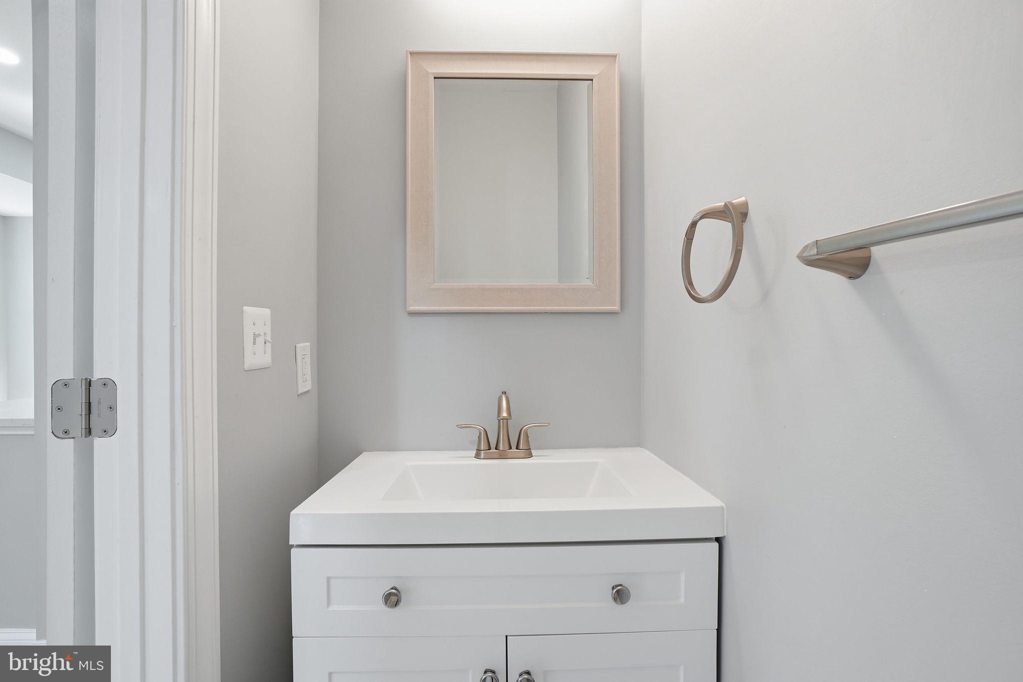 3337 5th Street Southeast Washington, DC 20032 - Photo 13 of 31 a bathroom with a sink and a mirror