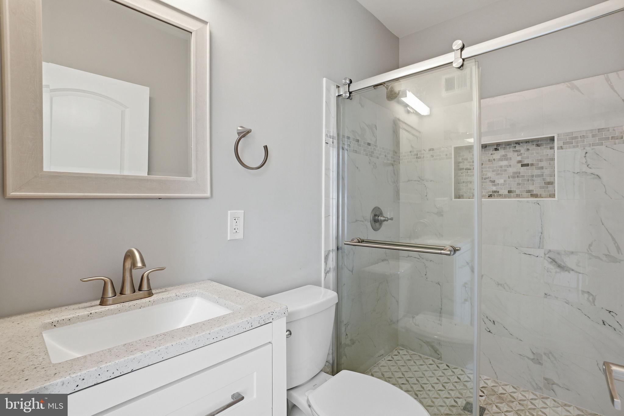 3337 5th Street Southeast Washington, DC 20032 - Photo 17 of 31 a bathroom with a shower sink vanity mirror and toilet