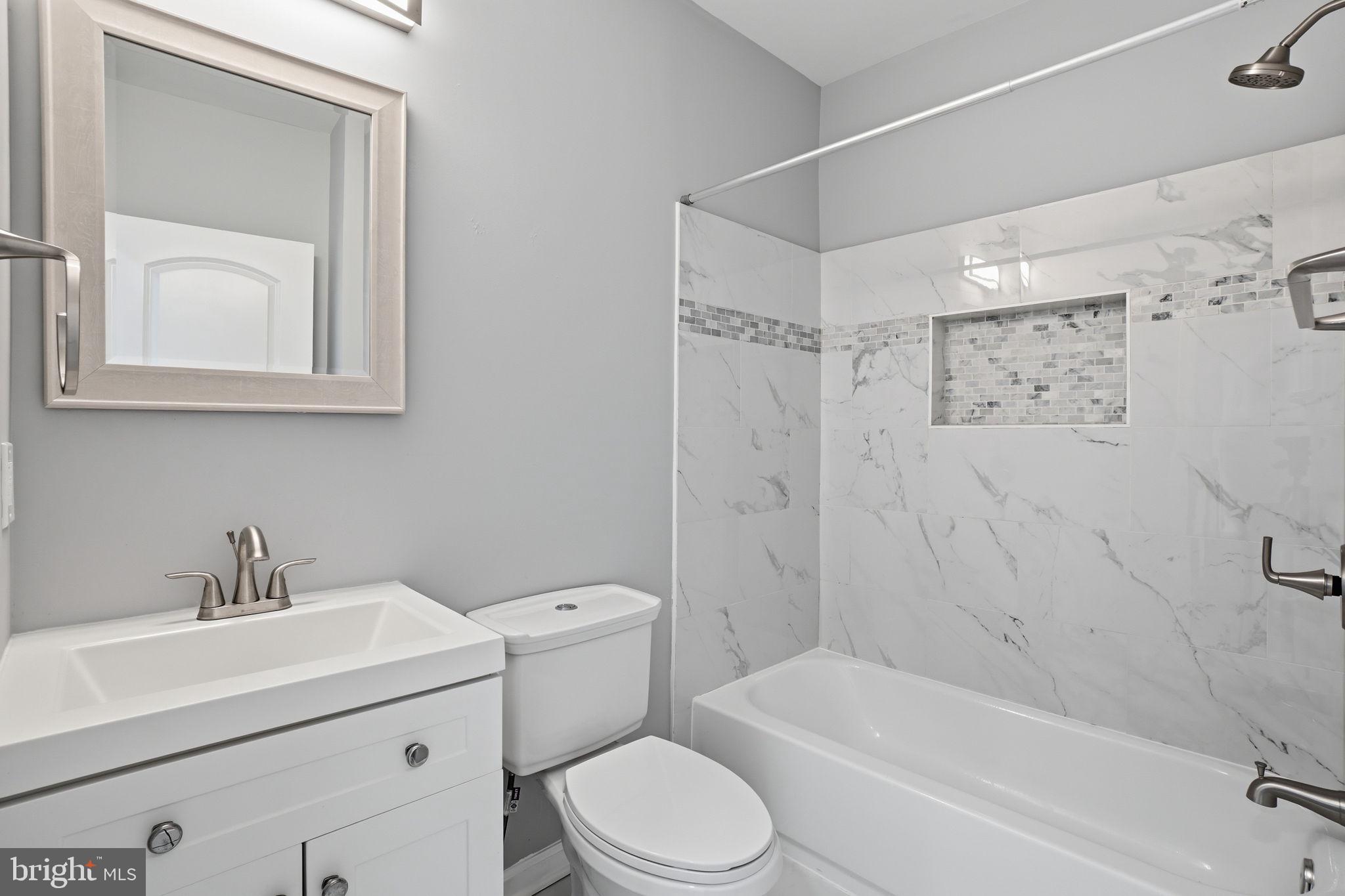 3337 5th Street Southeast Washington, DC 20032 - Photo 21 of 31 a bathroom with a toilet sink vanity tub and shower