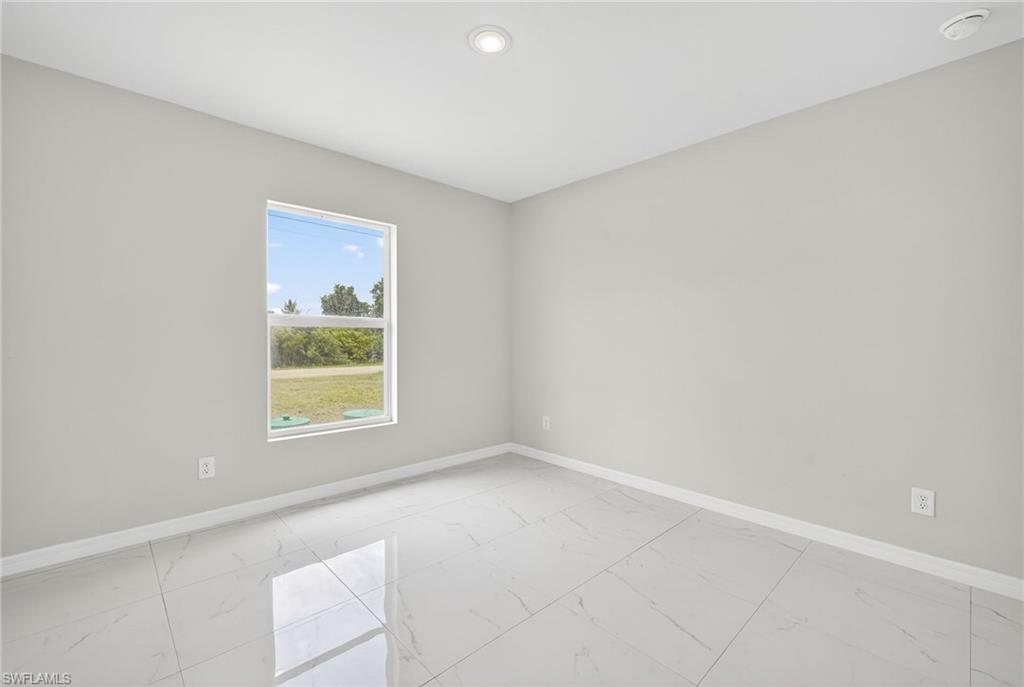 321 Ranier Avenue Lehigh Acres, FL 33974 - Photo 18 of 40 an empty room with windows