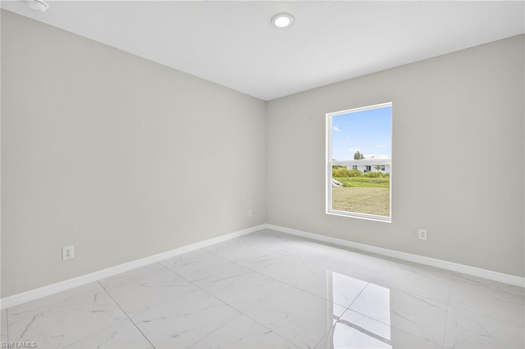 321 Ranier Avenue Lehigh Acres, FL 33974 - Photo 20 of 40 an empty room with a window