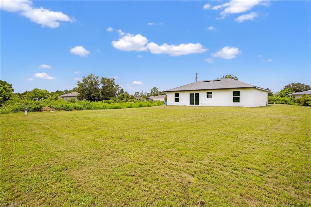 321 Ranier Avenue Lehigh Acres, FL 33974 - Photo 25 of 40 a view of a house with a ocean view