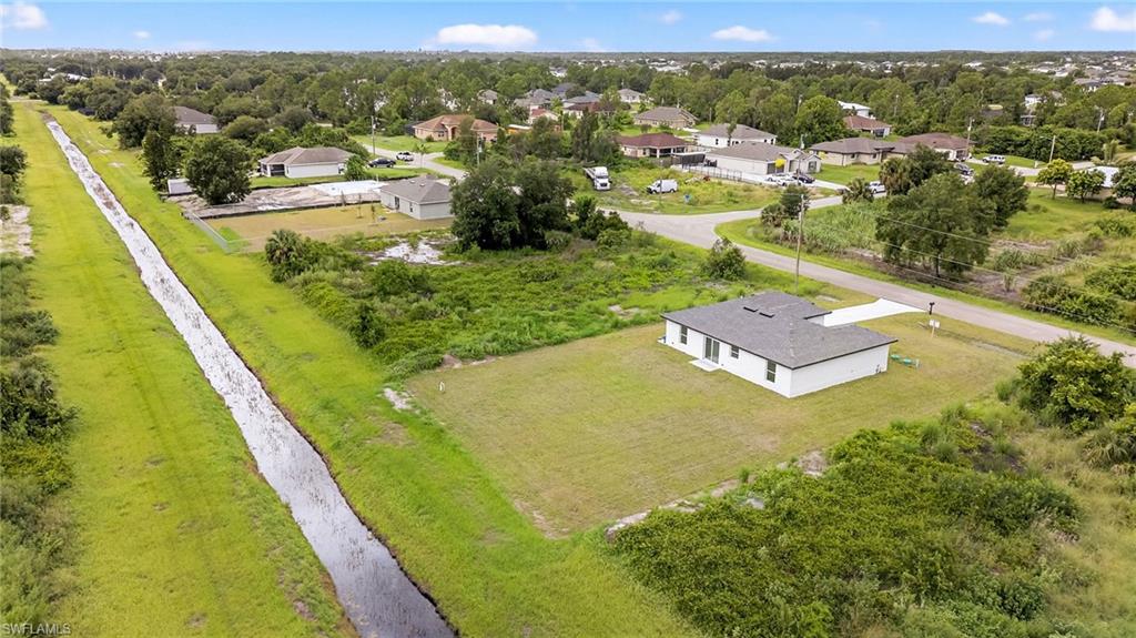321 Ranier Avenue Lehigh Acres, FL 33974 - Photo 32 of 40 a view of a lake with a building in the background
