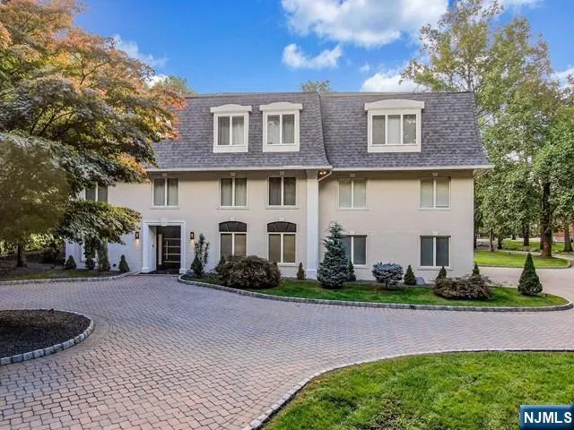 a front view of a house with a garden and plants
