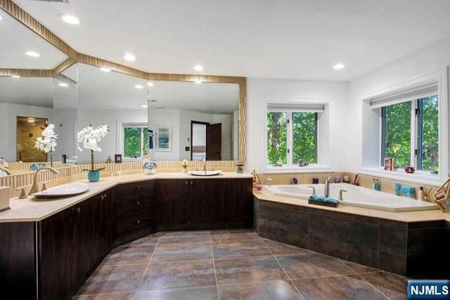 99 Ogle Road Old Tappan, NJ 07675 - Photo 32 of 50 a large bathroom with a large tub and sink