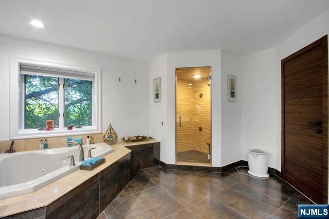 99 Ogle Road Old Tappan, NJ 07675 - Photo 33 of 50 a bathroom with a tub and a window