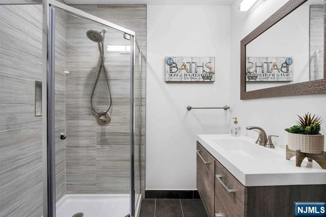 99 Ogle Road Old Tappan, NJ 07675 - Photo 44 of 50 a bathroom with a sink a mirror and a shower