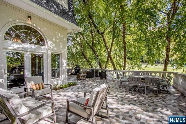 99 Ogle Road Old Tappan, NJ 07675 - Photo 45 of 50 a view of a dinning table and chairs in the patio